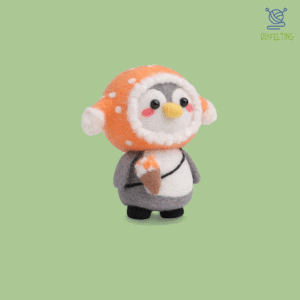 The finished Ice Cream Penguin felted figure, happily holding a double-scoop ice cream cone.